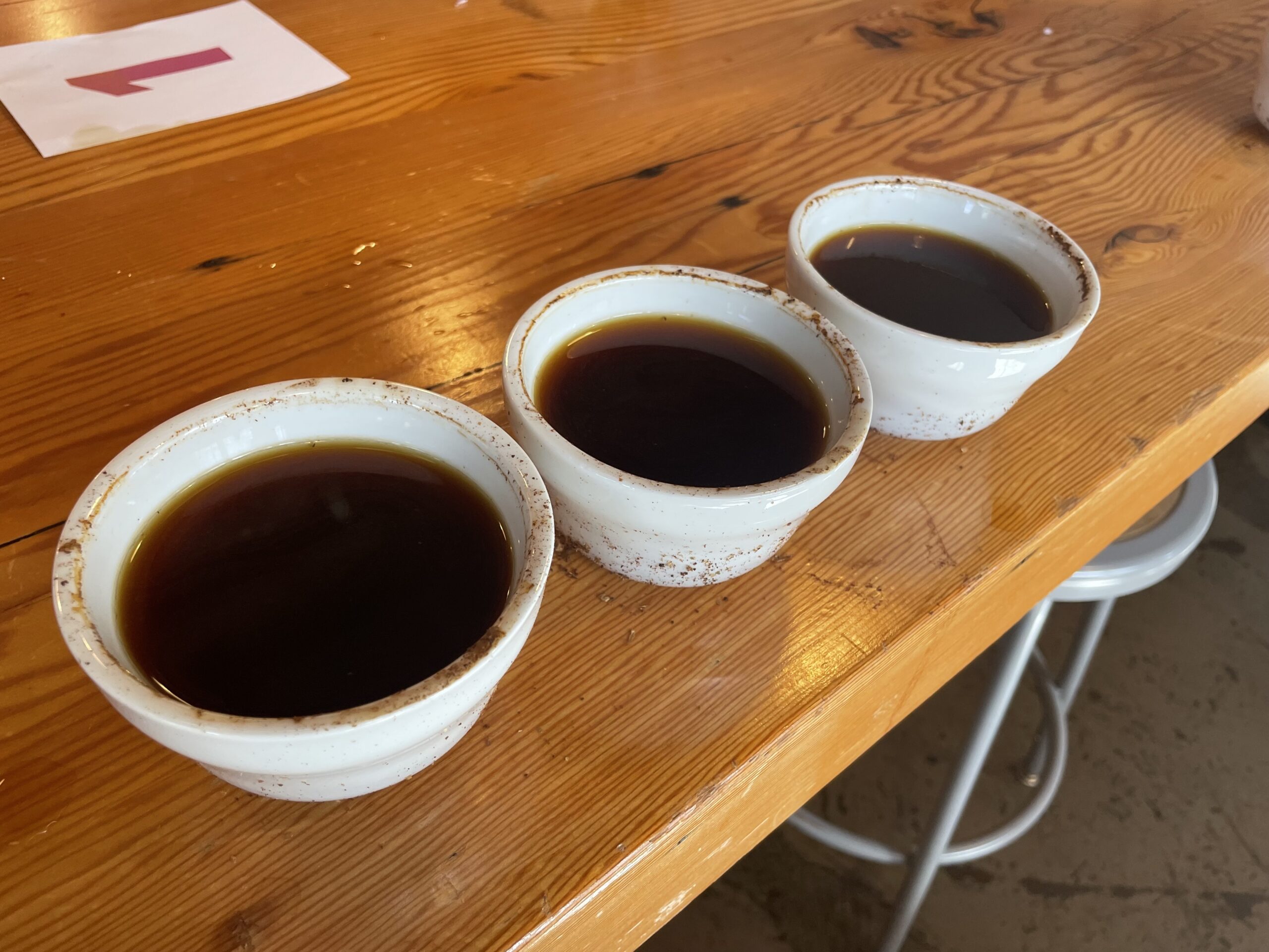 Three cups of coffee on a wooden table 