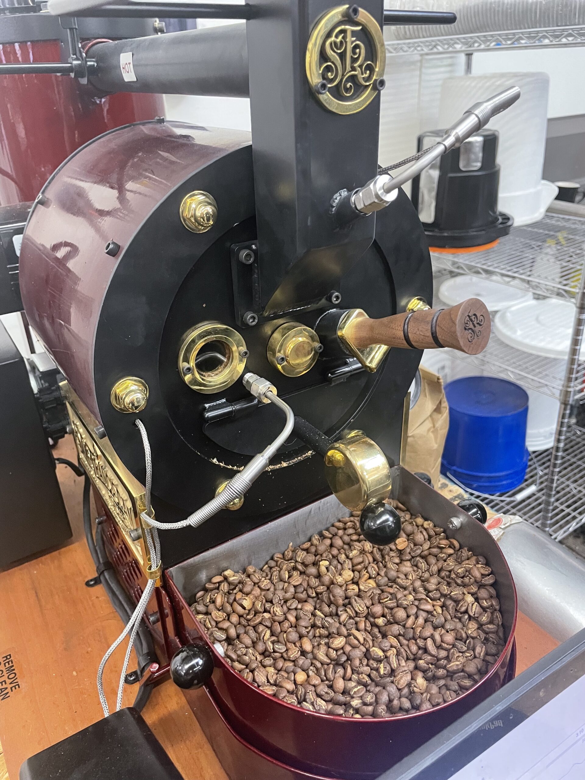 Roaster with freshly roasted coffee beans 